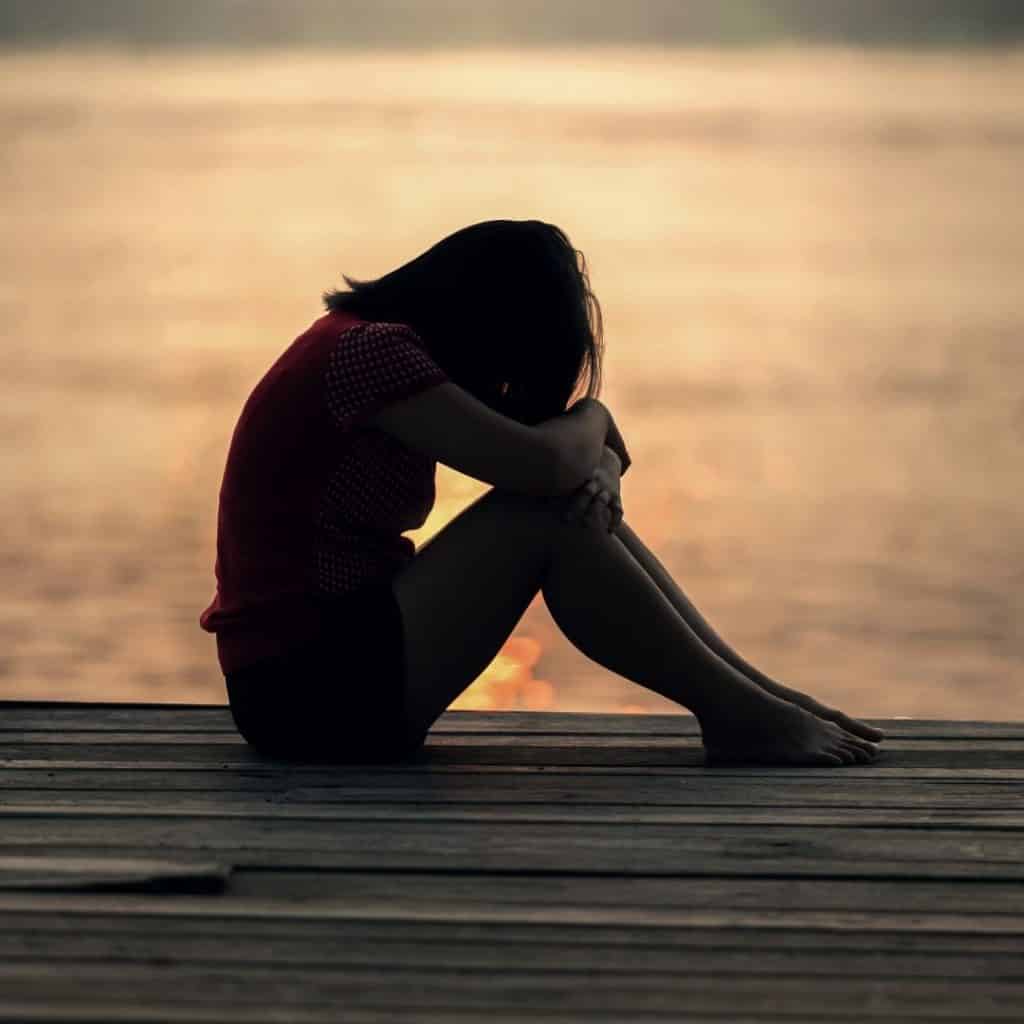 sad women in sunset recovering from trauma