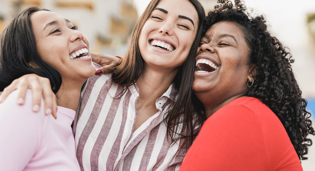 Three women laughing together