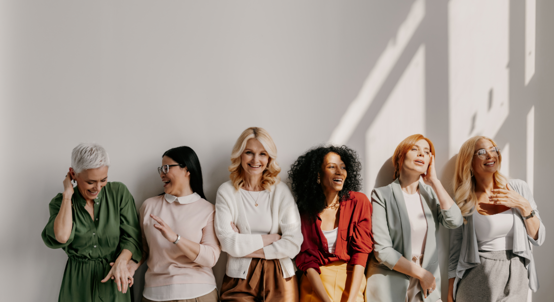 6 women in a row smiling