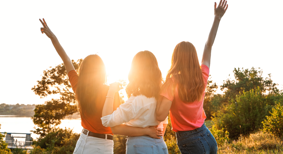 three women facing the sun 