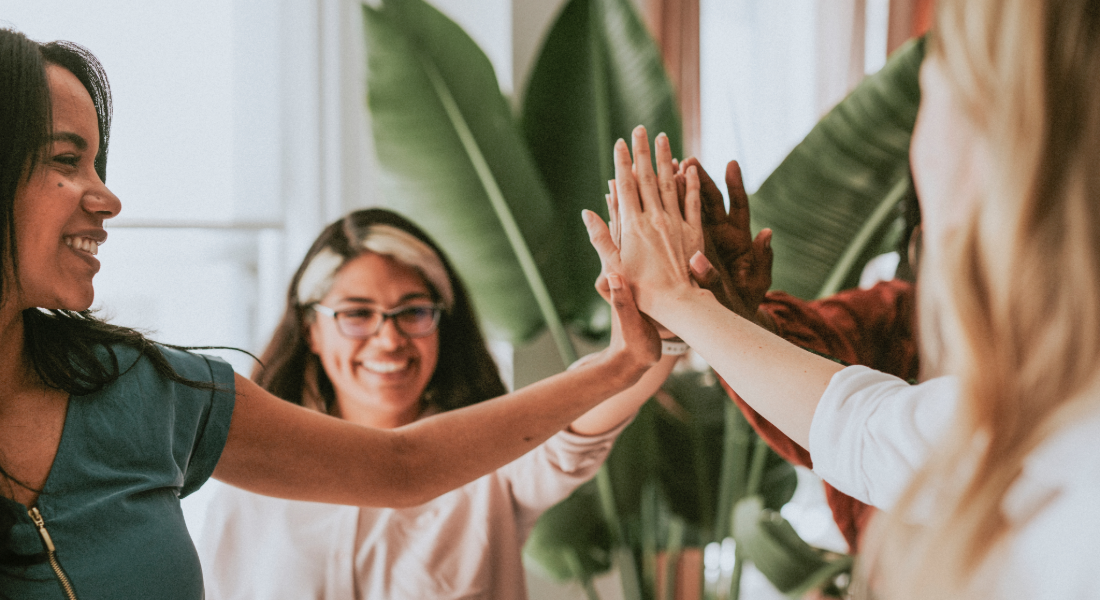 a group of women high-fiving