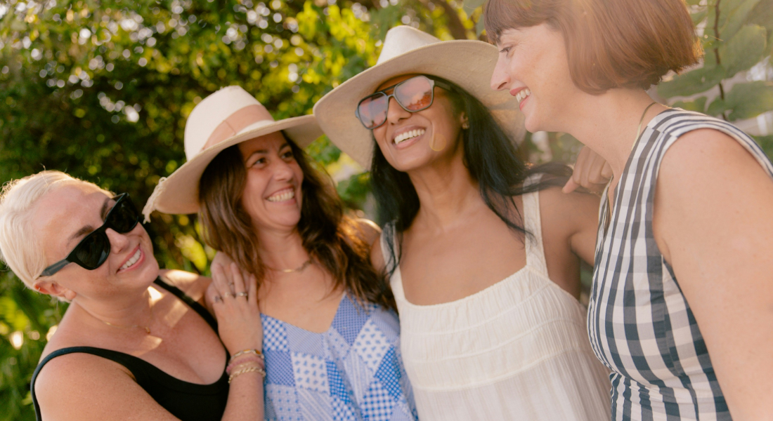 4 women outside smiling