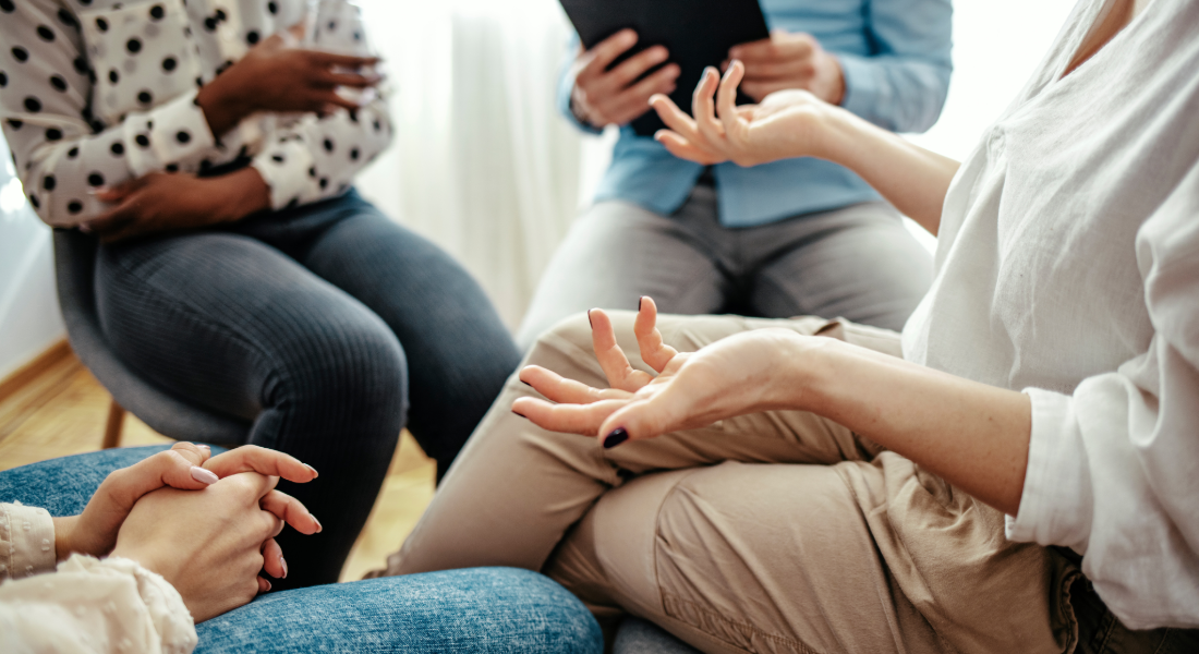 women seated in a circle talking